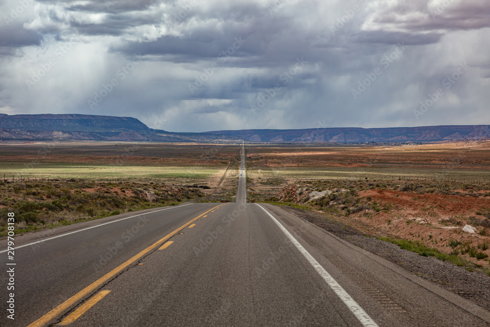 Long highway in the american desert, cloudy sky