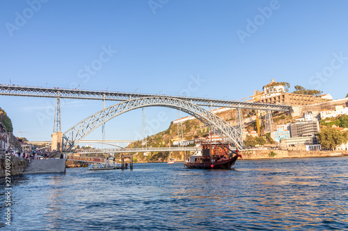 Tourist boat in Porto, Portugal, in front of Dom Luis Bridge