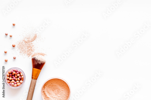 Brushes for make up, blusher and powder on white visagiste work desk background top view copyspace photo