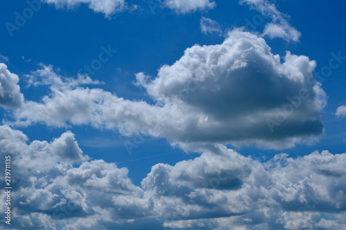 photo of blue sky with heavy gray-white clouds