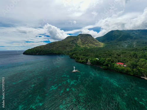 Aerial view of the sunken cemetery off the coast of the green volcanic island of Camiguin photo