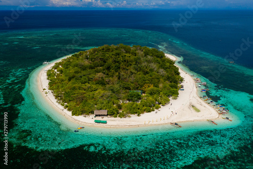 Aerial view of a beautiful tropical island surrounded by coral reef (Mantigue Island, Camiguin, Philippines)