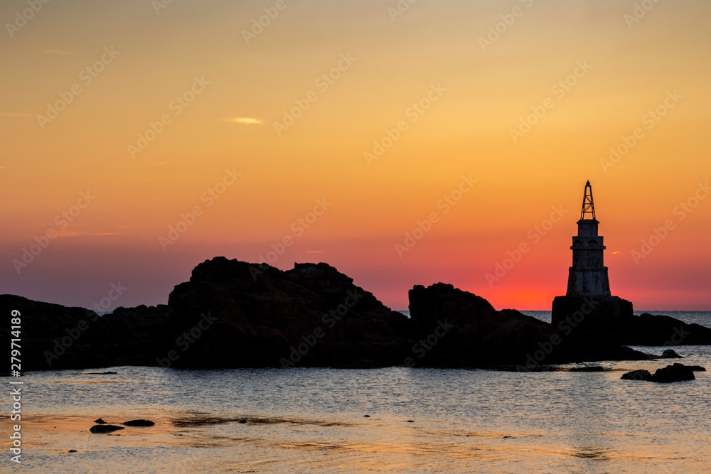 Scenic sunrise behind the Ahtopol lighthouse at the Bulgarian Black Sea Coast