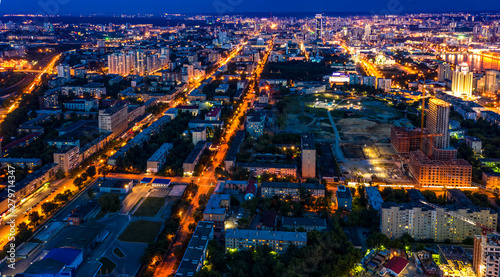 Panoramic aerial view of night illuminated city with lights