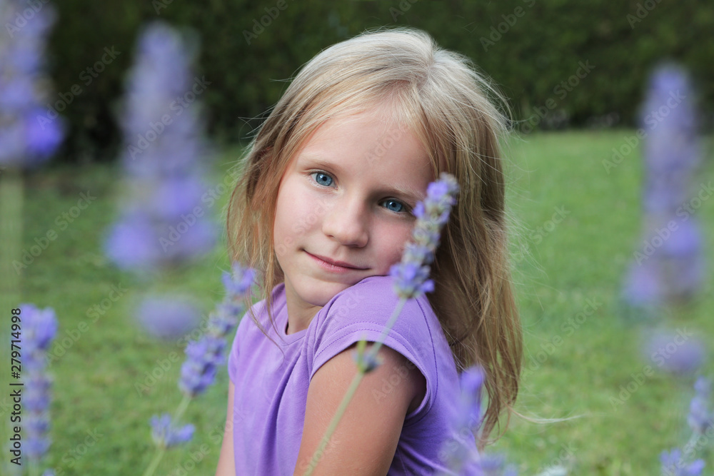 Beautiful smiling blond blue-eyed girl, portrait in a lavender flowers. Beautiful smiling blond blue-eyed girl, portrait in a lavender flowers.