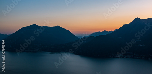 Mountains rising over the Lago di Como lake in the evening © erikzunec