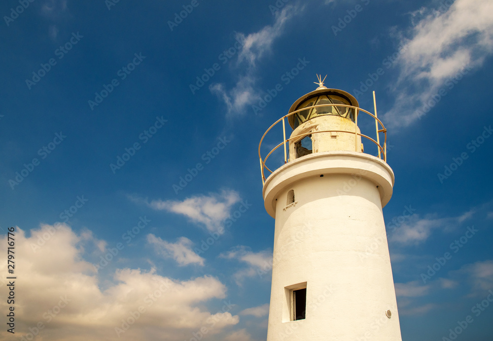 Low angle view of the top of a white lighthouse against a blue sky with clouds, Porto Maurizio, Imperia, Liguria, Italy