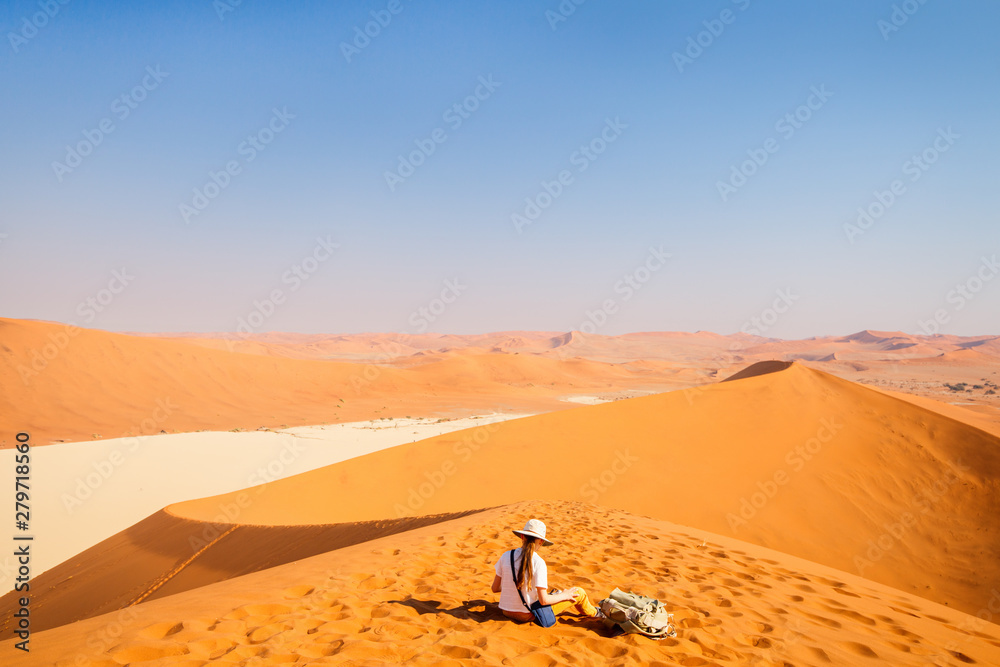 Little girl on red sand dune