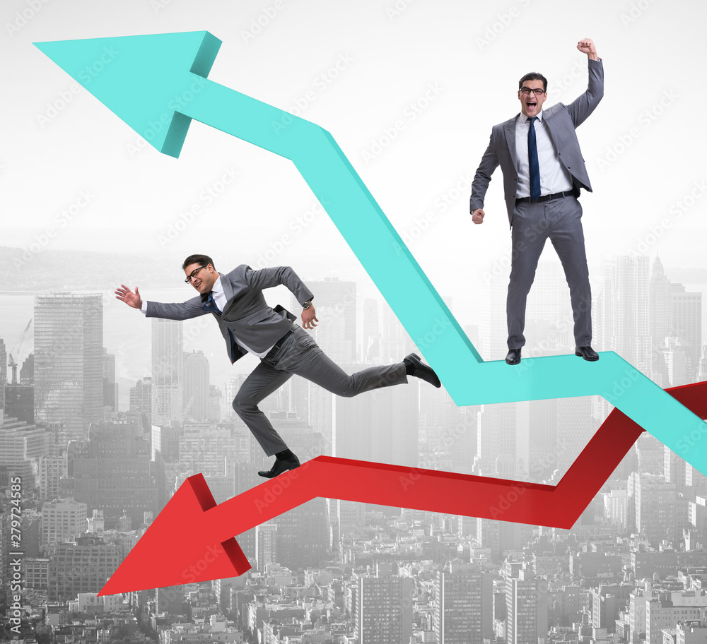 Businessman with charts of growth and decline Businessman with charts of growth and decline