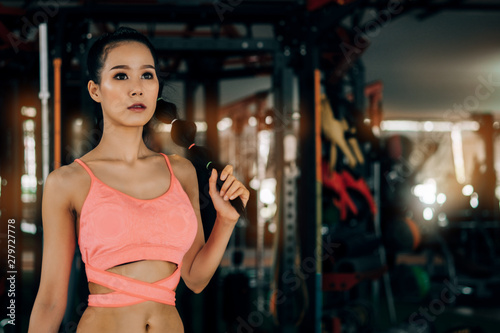sport woman at fitness gym club doing exercise for arms with kettlebell and showing muscle bodybuilding  fitness concept  sport concept