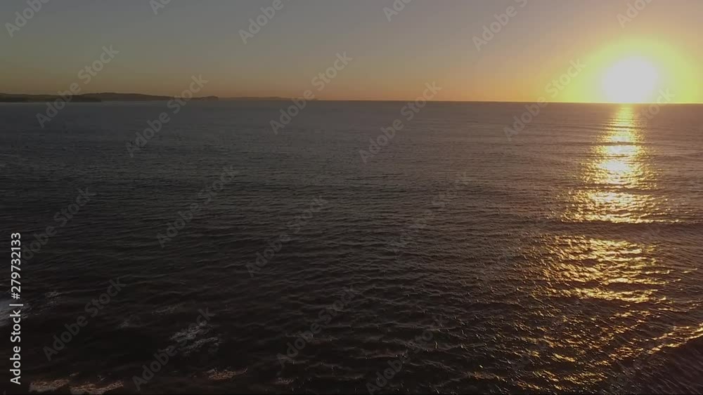 Sunrise drone shot over water with sun at right of frame. Long reef is a unique marine environment on the northern beaches of Sydney Australia. Sunrise drone shot over water with sun at right of frame. Long reef is a unique marine environment on the northern beaches of Sydney Australia.