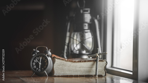 Fotografie, Obraz Close up woonden cross with clock and Bible, How much the time of man given to God,christian concept