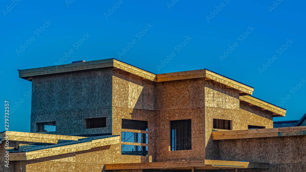 Panorama Exterior of a house under construction against vast blue sky on a sunny day