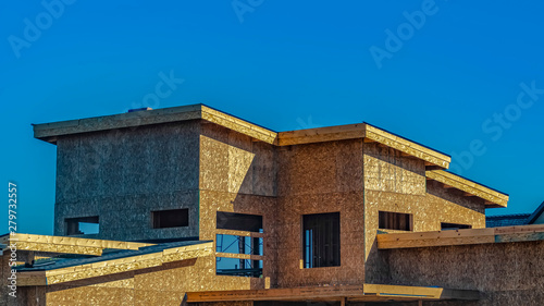 Panorama Exterior of a house under construction against vast blue sky on a sunny day