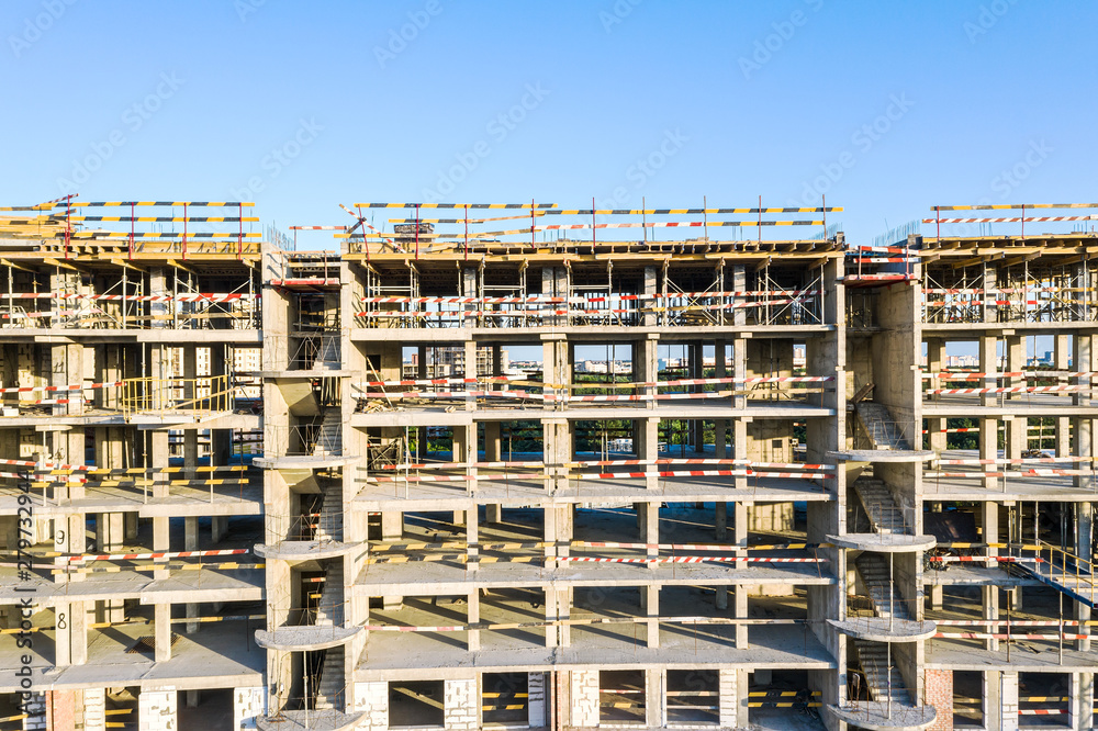 new apartment building under construction against blue sky background. aerial photography