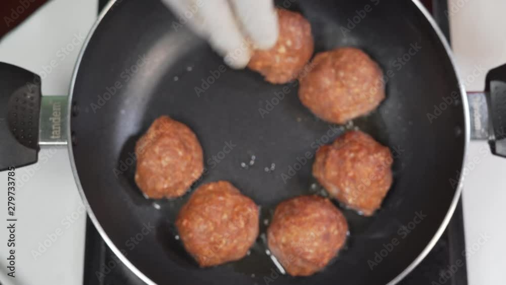 Chef In A Restaurant Kitchen frying pork meat balls in olive oil . Ketogenic Food Chef In A Restaurant Kitchen frying pork meat balls in olive oil . Ketogenic Food