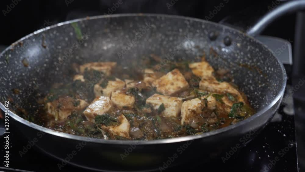 4k cinematic shot of stirring frying spinach and other tasty and exotic spices in a professional kitchen 4k cinematic shot of stirring frying spinach and other tasty and exotic spices in a professional kitchen