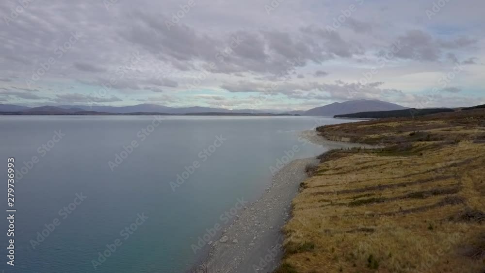 AERIAL reveal of Lake Pukaki, New Zealand with mountain ranges AERIAL reveal of Lake Pukaki, New Zealand with mountain ranges