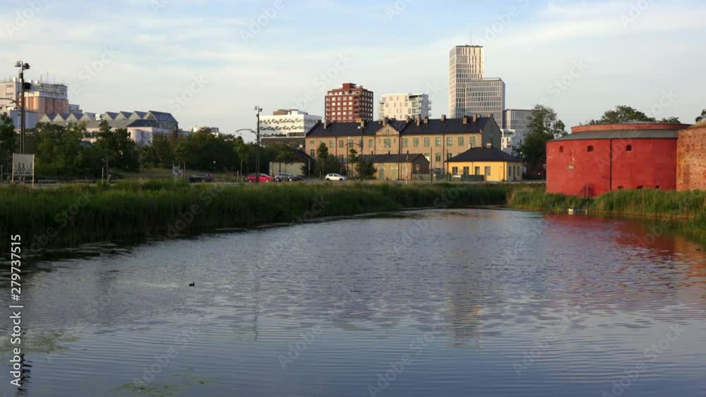 Malmo modern skyline next to a gun turret of the old castle on a golden summer evening. Sweden Malmo modern skyline next to a gun turret of the old castle on a golden summer evening. Sweden