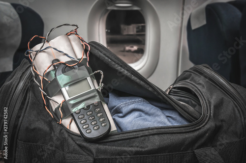 Dynamite bomb with phone in terrorist bag inside airplane photo