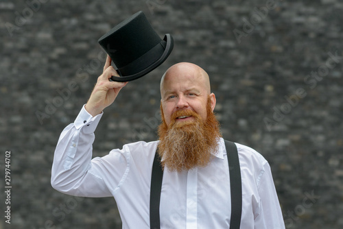 Happy genial man politely doffing his top hat