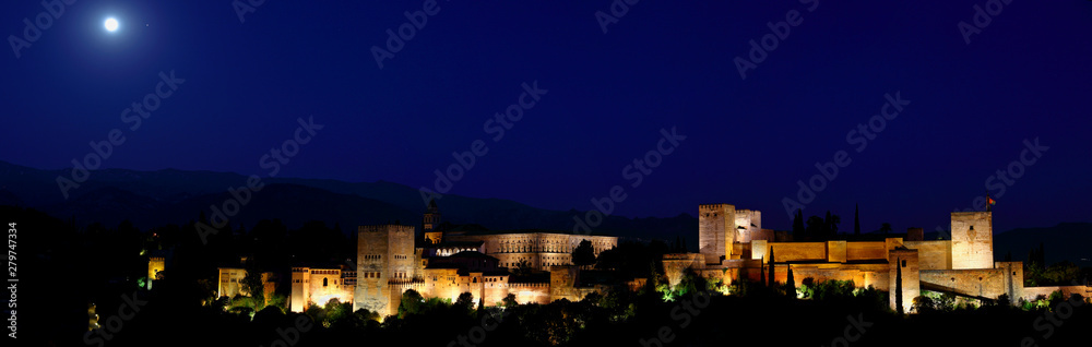 Panoramic view of Alhambra palace in the blue hours, Granada - Andalusia, Spain, viewed from Mirador San Nicolas. 