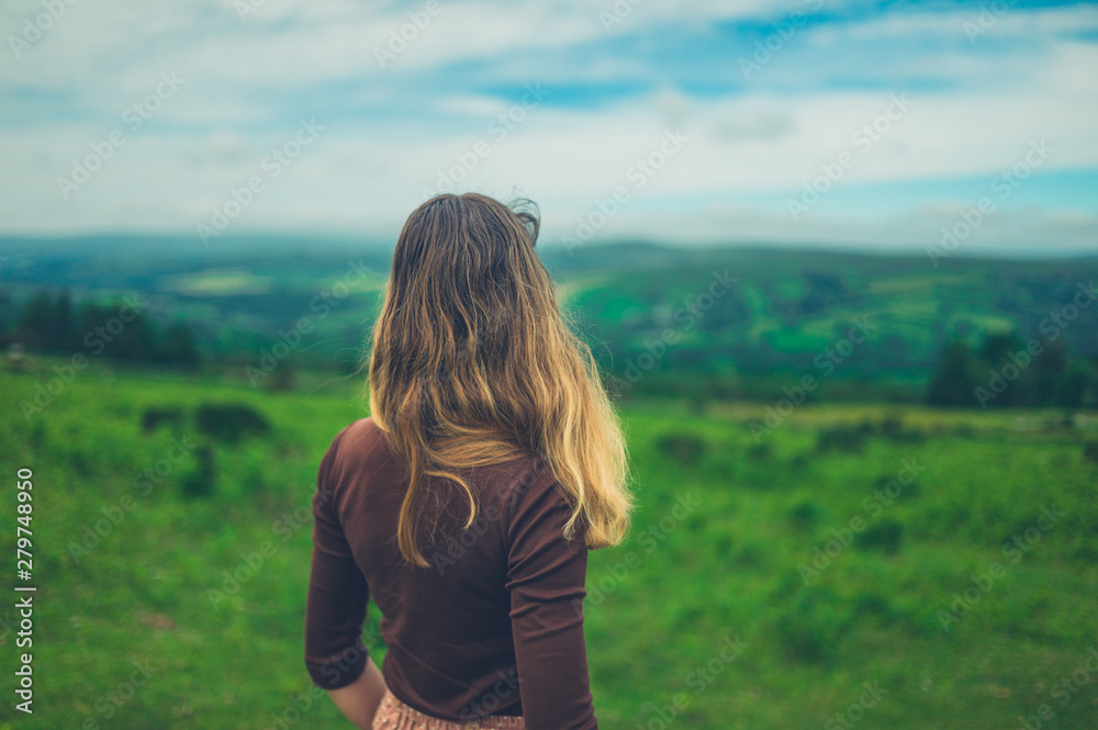 Young woman looking at landscape in summer Young woman looking at landscape in summer