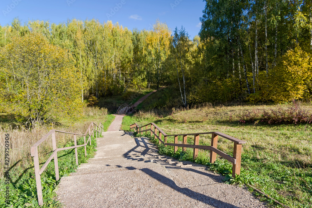 Footpath in the forest park. Sunny autumn day. Footpath in the forest park. Sunny autumn day.