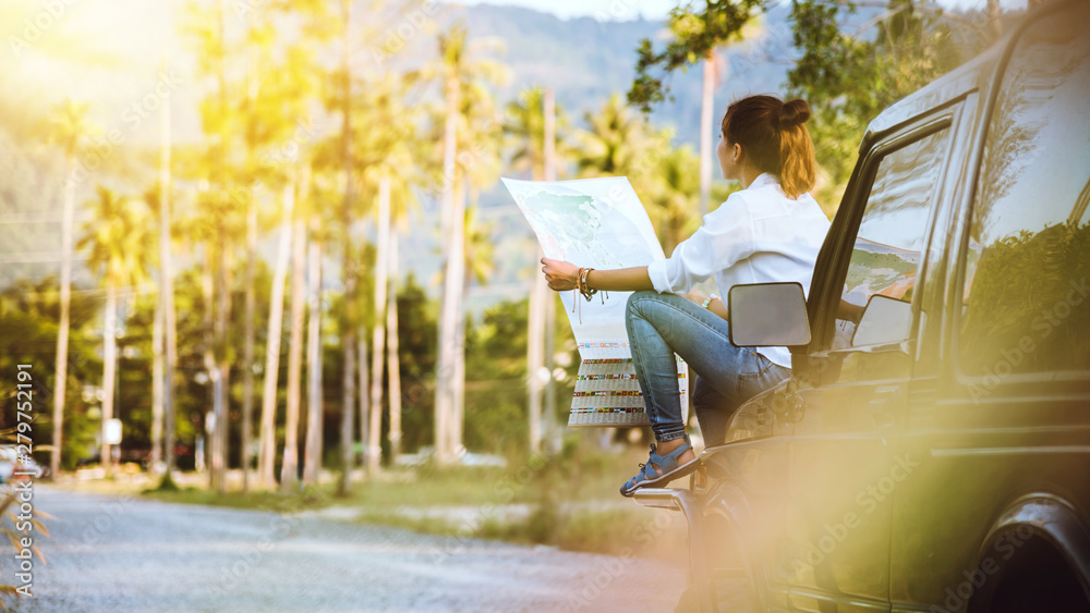 woman travel relaxing nature mountain map navigation. Sit on the car and browse the map.