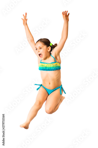 Little caucasian female 8 years old girl in multicoloured swimmwear jumping on white background.