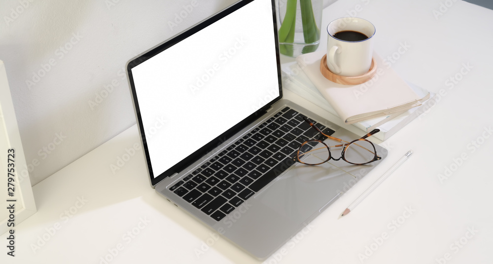 Business people's work place with blank screen laptop