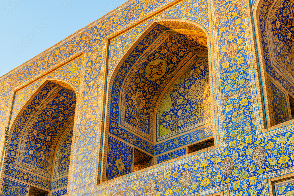 Arch niches covered with colorful mosaic tiles, the Shah Mosque