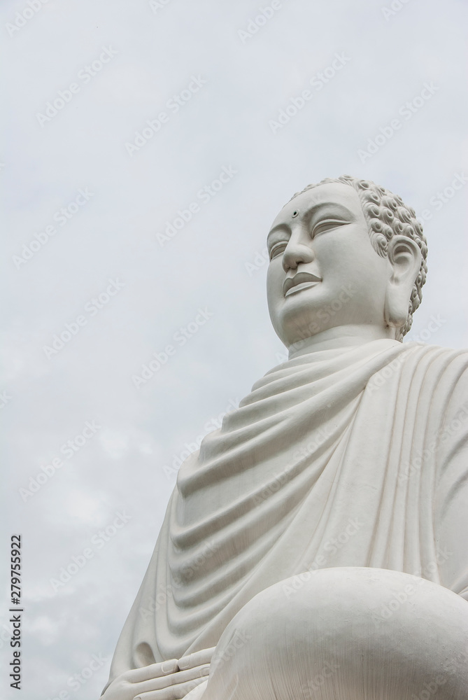 White buddha statue in the cloudy sky