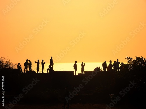beautiful human silhouettes during the golden hour at Fort, Agoda, Goa