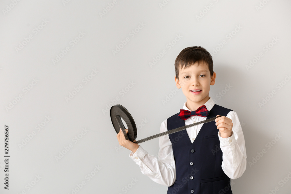 Little boy with film strip on white background Little boy with film strip on white background