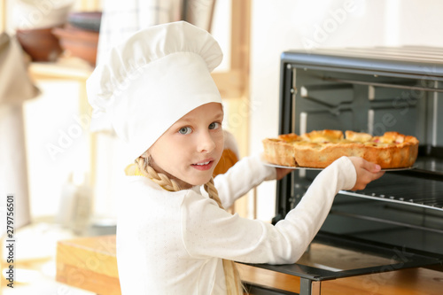 Cute little chef taking pie...