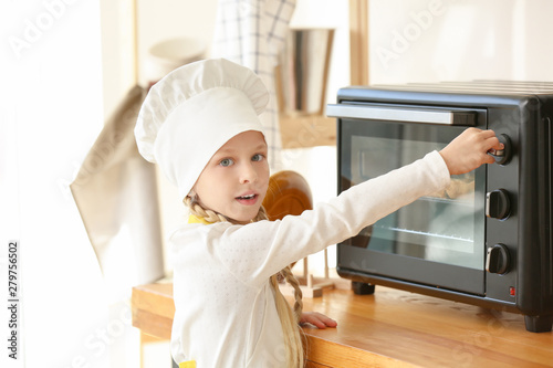 Cute little chef cooking in...
