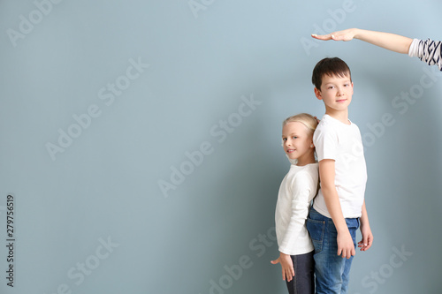 Mother measuring height of ...