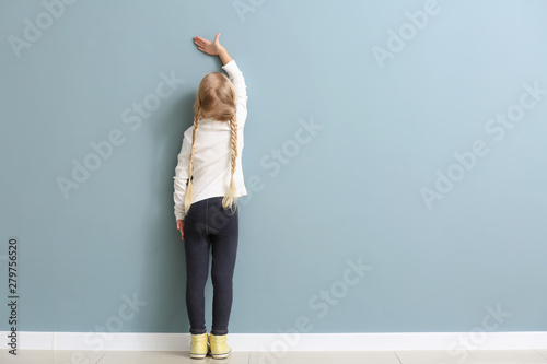 Cute little girl measuring ...