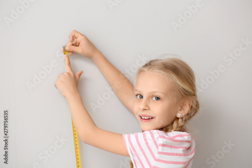 Cute little girl measuring ...