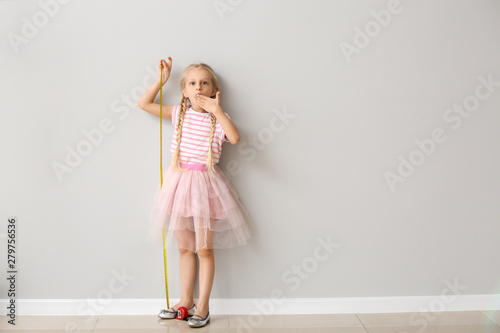 Cute little girl measuring ...