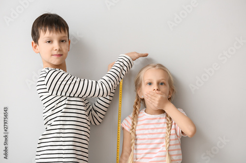 Cute little children measur...