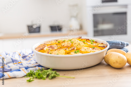 Roasted potatoes with spices and herbs on kitchen table