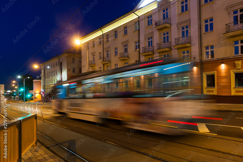 The motion of a blurred tram in the evening.