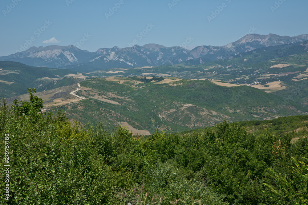 Green mountains covered with forest on the blue sky background. Panorama .Mountain green valley landscape. Beautiful mountain green valley panorama. Green mountains and mountain tops .