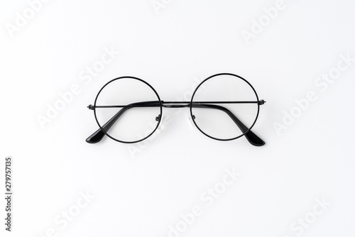 Black framed eyeglasses on white table. Top view