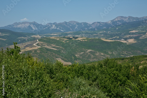 Green mountains covered with forest on the blue sky background. Panorama .Mountain green valley landscape. Beautiful mountain green valley panorama. Green mountains and mountain tops .