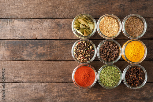Various kinds of colourful seasonings in bowls. Collection of spices
