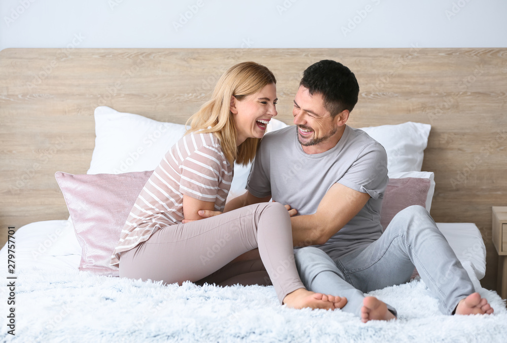 Portrait of happy couple on bed at home Portrait of happy couple on bed at home