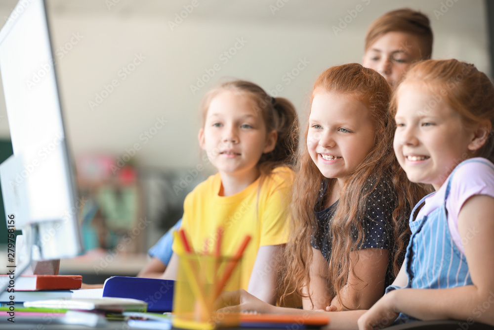 Cute little pupils during lesson in classroom Cute little pupils during lesson in classroom